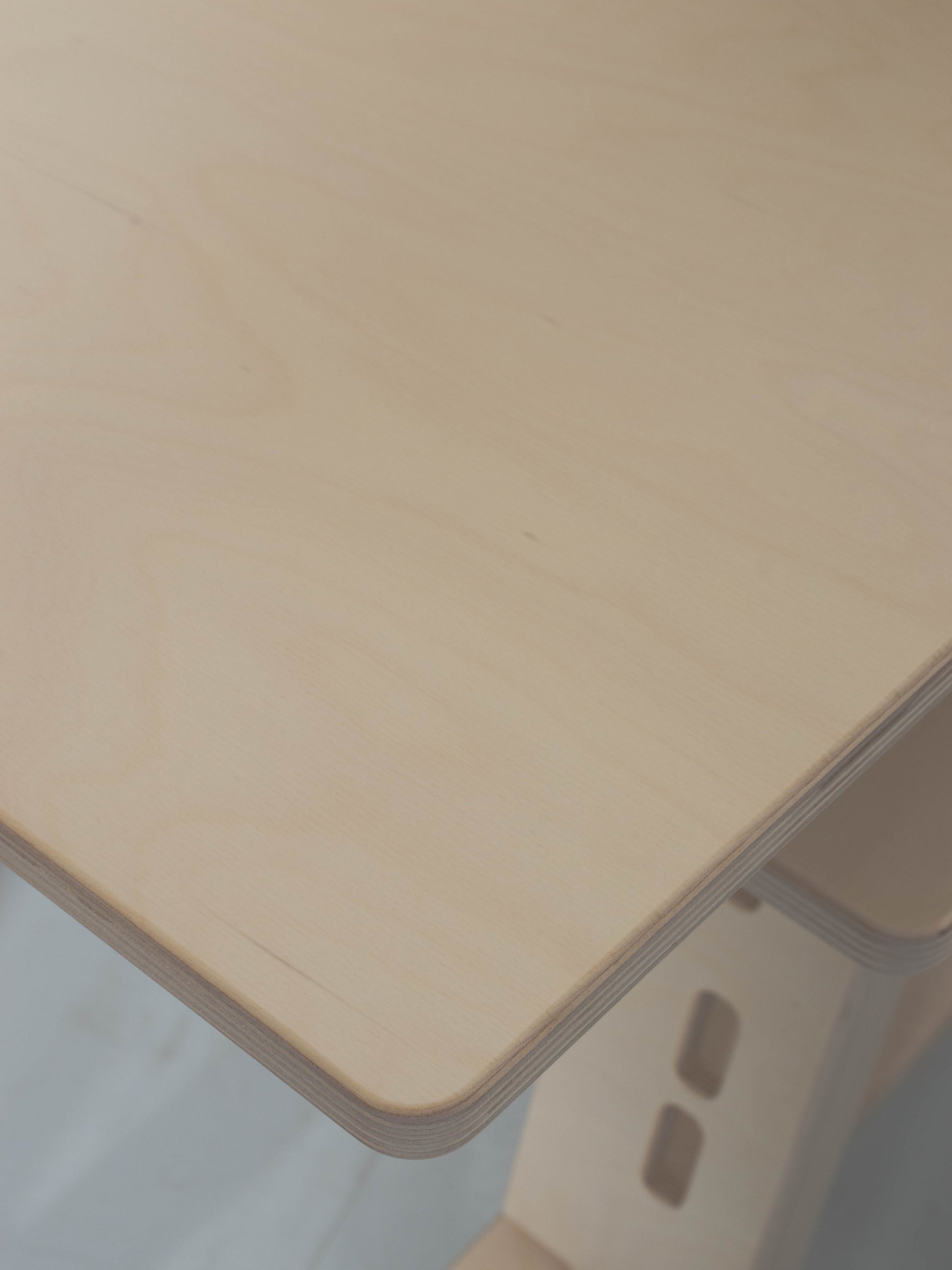 Natural wood desk surface with a blurred background