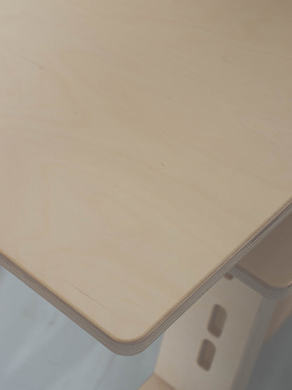 Natural wood desk surface with a blurred background